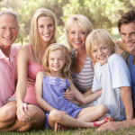 A family, with parents, children and grandparents, relaxing in a park