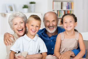 Happy young siblings with their grandparents
