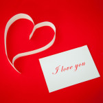 Paper heart on red background