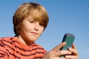 kid texting with cell or mobile phone
