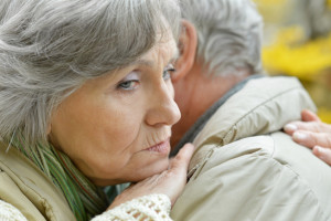 Portrait of a sad senior couple in autumn park