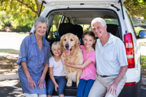 Grandparents going on road trip with grandchildren on a sunny day