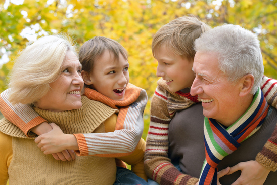 Grandparents and grandchildren together in autumn park